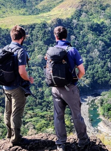 Two hikers looking down to forests along the banks of the Sigatoka River